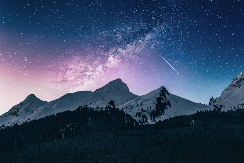 Starry night over foggy mountains